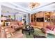 Spacious living room featuring built-in shelving and access to outdoor patio at 4740 Carrington Cir, Sarasota, FL 34243