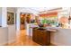 Open-concept living area with built-in shelves and sunny views of the outdoor pool at 4740 Carrington Cir, Sarasota, FL 34243