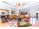 Bright living room boasts hardwood floors, ceiling fan, and comfortable seating at 4740 Carrington Cir, Sarasota, FL 34243