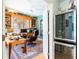 Inviting home office with custom wood built-ins, large window, and a modern wine refrigerator at 4740 Carrington Cir, Sarasota, FL 34243
