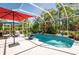 Sparkling pool surrounded by lush landscaping and a screened enclosure for year-round enjoyment at 4740 Carrington Cir, Sarasota, FL 34243