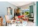 Comfortable sitting room featuring a plush sofa, a patterned chair, and bright natural light at 4740 Carrington Cir, Sarasota, FL 34243