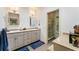 Well-lit bathroom with double sinks, granite countertops, and a glass-enclosed shower, offering a spa-like experience at 4852 Peregrine Point N Cir, Sarasota, FL 34231