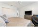 Cozy bedroom features a wall of closet space and a light, neutral color palette at 4852 Peregrine Point N Cir, Sarasota, FL 34231