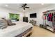 A bright bedroom has a ceiling fan, tile floor, and a large window that offer natural light at 4852 Peregrine Point N Cir, Sarasota, FL 34231