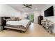 Spacious bedroom with a sliding glass door, tile flooring, and a ceiling fan, offering a serene retreat at 4852 Peregrine Point N Cir, Sarasota, FL 34231