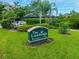Community entrance sign for 'The Landings Racquet Club' surrounded by green lawns and manicured landscaping at 4852 Peregrine Point N Cir, Sarasota, FL 34231