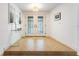 Foyer with tile flooring, glass console table, and white double doors at 4852 Peregrine Point N Cir, Sarasota, FL 34231