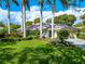 Well-maintained front yard features lush landscaping and a charming home with a welcoming entrance and driveway at 4852 Peregrine Point N Cir, Sarasota, FL 34231