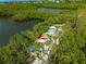 An aerial view of many colorful kayaks lined up along the waters edge at 4852 Peregrine Point N Cir, Sarasota, FL 34231