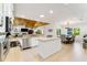 Stylish kitchen with an island, stainless steel appliances, and an adjacent dining area at 4852 Peregrine Point N Cir, Sarasota, FL 34231
