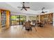 Community library with bookshelves, tables, and large windows overlooking a serene landscape at 4852 Peregrine Point N Cir, Sarasota, FL 34231