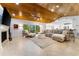 Spacious living room with a wooden ceiling, plush seating, and a fireplace at 4852 Peregrine Point N Cir, Sarasota, FL 34231