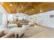 Bright living room featuring wood ceilings and seamless flow into the open-concept kitchen at 4852 Peregrine Point N Cir, Sarasota, FL 34231