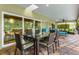 Covered patio offers an outdoor dining area with furniture and views of the pool at 4852 Peregrine Point N Cir, Sarasota, FL 34231