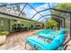 The screened-in pool area features lounge chairs, an outdoor dining set, and ample seating, perfect for relaxation and entertaining at 4852 Peregrine Point N Cir, Sarasota, FL 34231