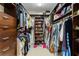 Spacious walk-in closet with custom shelving and storage solutions, ideal for organizing clothes and accessories at 4852 Peregrine Point N Cir, Sarasota, FL 34231