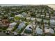 Aerial view of canal-front homes in a coastal community near the bay at sunset at 516 Kumquat Dr, Anna Maria, FL 34216