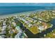 Aerial view of a waterfront community with a private dock near the ocean at 516 Kumquat Dr, Anna Maria, FL 34216