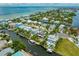 Aerial shot of the home with canal access and a boat lift, showcasing waterfront living at 516 Kumquat Dr, Anna Maria, FL 34216