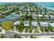 Aerial view of a waterfront community with canals, homes, and access to the bay at 516 Kumquat Dr, Anna Maria, FL 34216