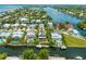 Aerial view of waterfront homes along canals, highlighting boating access and community layout at 516 Kumquat Dr, Anna Maria, FL 34216