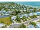 Aerial view showcasing the home's location within a waterfront community near the bay at 516 Kumquat Dr, Anna Maria, FL 34216