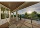Balcony with wood-like flooring with views of trees and the morning sun at 516 Kumquat Dr, Anna Maria, FL 34216