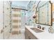 Charming bathroom with fish-themed wallpaper, elegant fixtures, and a shower-tub combination at 516 Kumquat Dr, Anna Maria, FL 34216