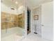 Modern bathroom with rain shower head, tiled shower, and glass door at 516 Kumquat Dr, Anna Maria, FL 34216