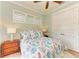 Comfortable bedroom featuring a ceiling fan, light blue walls and carpeted flooring at 516 Kumquat Dr, Anna Maria, FL 34216