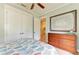 Bright bedroom featuring light walls, white trim, and coordinating patterned bedding at 516 Kumquat Dr, Anna Maria, FL 34216