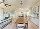 Open-concept dining area with hardwood floors, stylish lighting, and a view of the staircase at 516 Kumquat Dr, Anna Maria, FL 34216