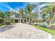 Elegant two-story home with a spacious driveway, a two car garage and lush landscaping, offering great curb appeal at 516 Kumquat Dr, Anna Maria, FL 34216