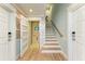 Hallway with a decorative seahorse, wooden stairs, and an elevator at 516 Kumquat Dr, Anna Maria, FL 34216