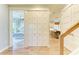 Hallway featuring hardwood floors leading to the kitchen and bedroom at 516 Kumquat Dr, Anna Maria, FL 34216