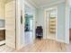 Inviting hallway leading to an office and bathroom with beautiful wood floors at 516 Kumquat Dr, Anna Maria, FL 34216