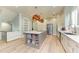 Spacious kitchen with hardwood floors, a center island, stainless steel appliances, and custom cabinets at 516 Kumquat Dr, Anna Maria, FL 34216