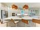 Bright kitchen features modern stainless appliances, a large center island and quartz countertops at 516 Kumquat Dr, Anna Maria, FL 34216