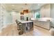 Modern kitchen featuring a quartz island, bar seating, stainless steel appliances, and custom cabinets at 516 Kumquat Dr, Anna Maria, FL 34216