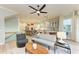 Bright and airy living room showcasing a modern ceiling fan, comfortable seating, and hardwood floors at 516 Kumquat Dr, Anna Maria, FL 34216