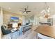 Living room with a stone accent wall, an open floorplan, and modern furnishings at 516 Kumquat Dr, Anna Maria, FL 34216
