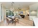 Spacious living room with a dining table, outdoor views, and modern decor at 516 Kumquat Dr, Anna Maria, FL 34216