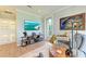 Comfortable living room provides access to a balcony and features a large flatscreen TV at 516 Kumquat Dr, Anna Maria, FL 34216