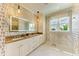 Modern bathroom featuring double sinks with granite countertops, decorative wallpaper, and marble floors at 516 Kumquat Dr, Anna Maria, FL 34216