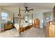 Spacious main bedroom with a ceiling fan, wood floors, and large windows for ample natural light at 516 Kumquat Dr, Anna Maria, FL 34216