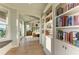 Bright main bedroom features a bookshelf and entry to the bedroom with hardwood floors at 516 Kumquat Dr, Anna Maria, FL 34216