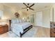 Comfortable main bedroom featuring a king bed, hardwood floors, and an ensuite bathroom at 516 Kumquat Dr, Anna Maria, FL 34216