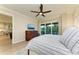 Spacious main bedroom with access to balcony, hardwood floors, with a glimpse into the kitchen and dining area at 516 Kumquat Dr, Anna Maria, FL 34216
