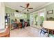 Sun-filled office space with neutral paint, wood floors, and access to a balcony at 516 Kumquat Dr, Anna Maria, FL 34216